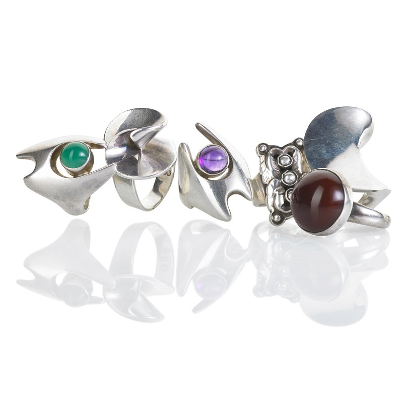 SIX DANISH STERLING RINGS BY GEORG JENSEN: #62 with silver "pearls", size 7; #123 with carnelian, designed by Nanna Ditzel, size 6 1/2; #139 with chrysoprase or amethyst, designed by Henning Koppel, sizes 8 and 9; #92 and #130, sizes 7 and 8.