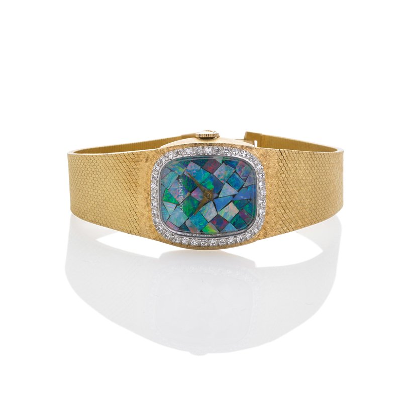 LONGINES OPAL DIAMOND 14K GOLD BRACELET WATCH: Cushion shaped midsize watch, opal mosaic numberless dial, single cut diamond bezel and textured strap, 17 jewel movement R 528, #53190496, case R #6622, #291412, ca. 1965. Adjusts 6 3/4" - 7", tapers