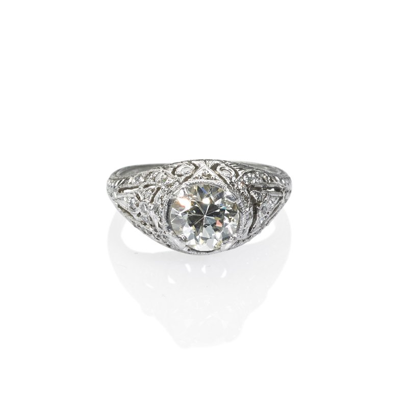 EDWARDIAN DIAMOND PLATINUM FILIGREE RING: Transitional cut diamond, approx. 1.1 cts. in lacey pierced and engraved setting with diamond accents. Size 5. 3.1 dwt. Property from the collection of Gray Davis Boone.