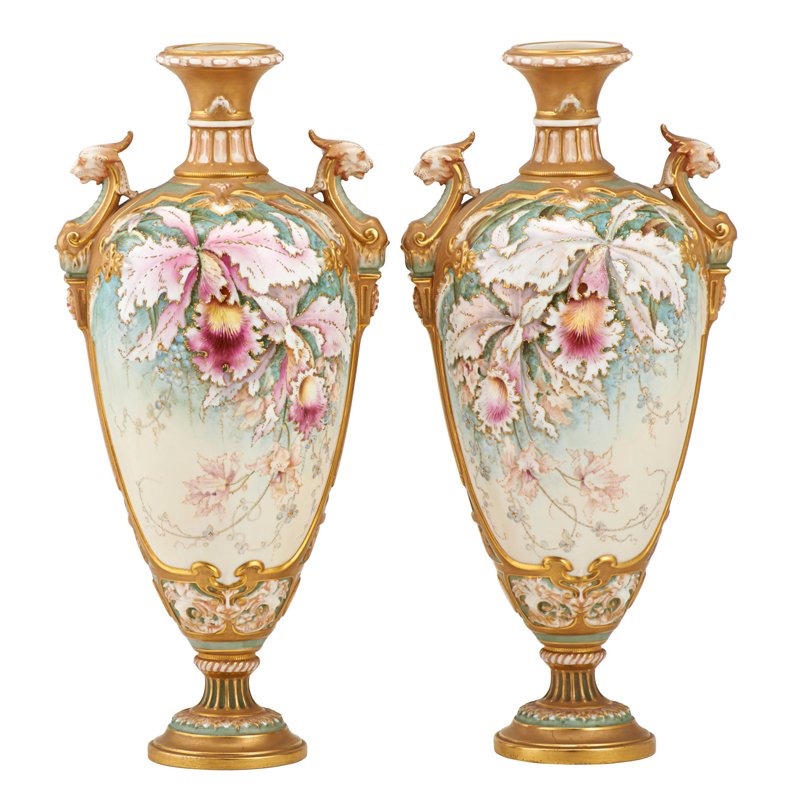 PAIR OF ROYAL WORCESTER PORCELAIN URNS: Hand-painted floral design with gilt lion head handles, late 19th c.; Marked; 15"
