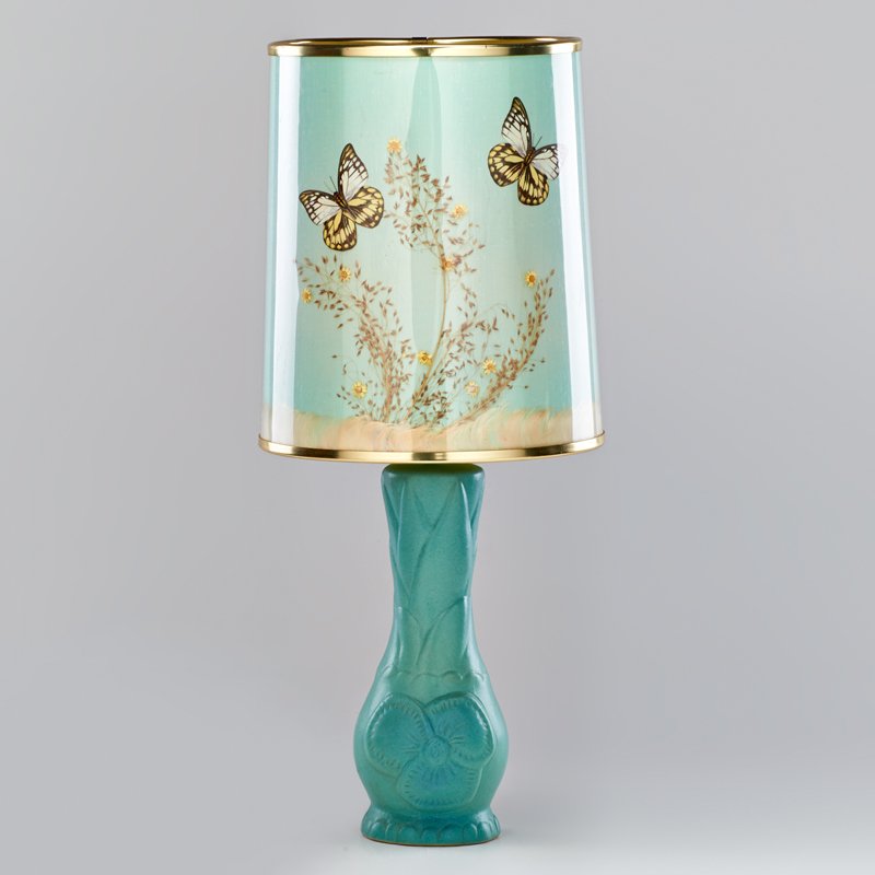 VAN BRIGGLE: Floral table lamp in blue glaze with original butterfly shade, Colorado Springs, CO; Marked Van Briggle Colo. Spgs. and artist cipher; 23 1/2" x 9 1/4" dia.
