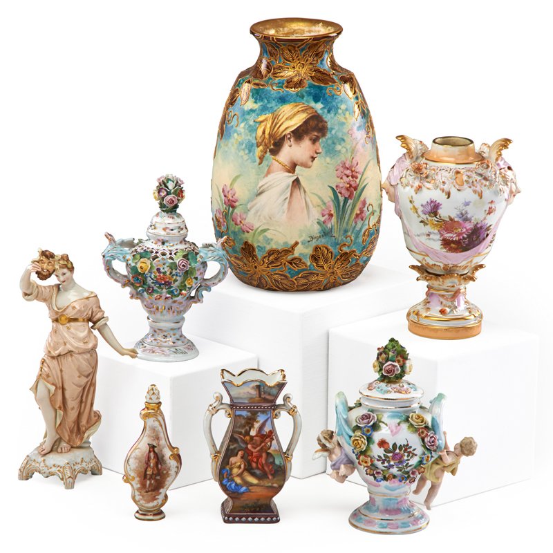 GERMAN PORCELAIN: Seven items, late 19th/early 20th c.: figural urn, scent bottle and bacchante by KPM; vase with young girl by Royal Bonn and two urns and a vase by unknown makers; Most marked; Tallest: 8"