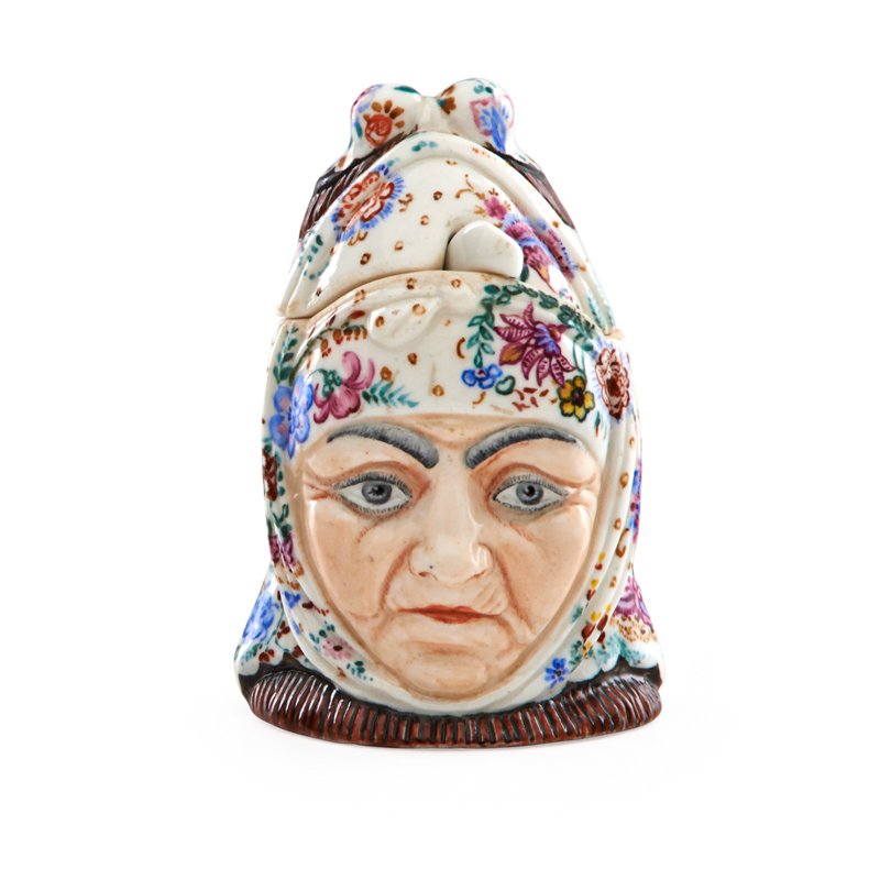 SOVIET PORCELAIN FIGURAL MUSTARD JAR AND SPOON: Russian elder in traditional dress, mid 20th c.; Hammer and sickle mark; 4 1/4"