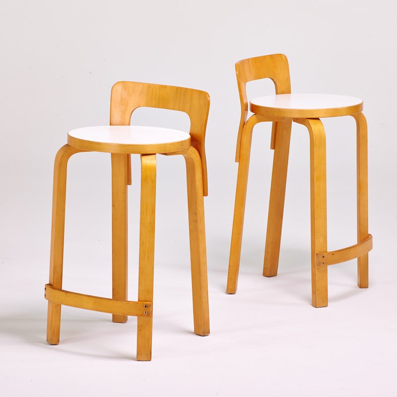 ALVAR AALTO; ARTEK: Pair of tall stools, Finland, 1980s; Birch plywood, enameled seats; Remains of sticker label; Each: 28 1/2" x 14 1/2" x 14 1/2"