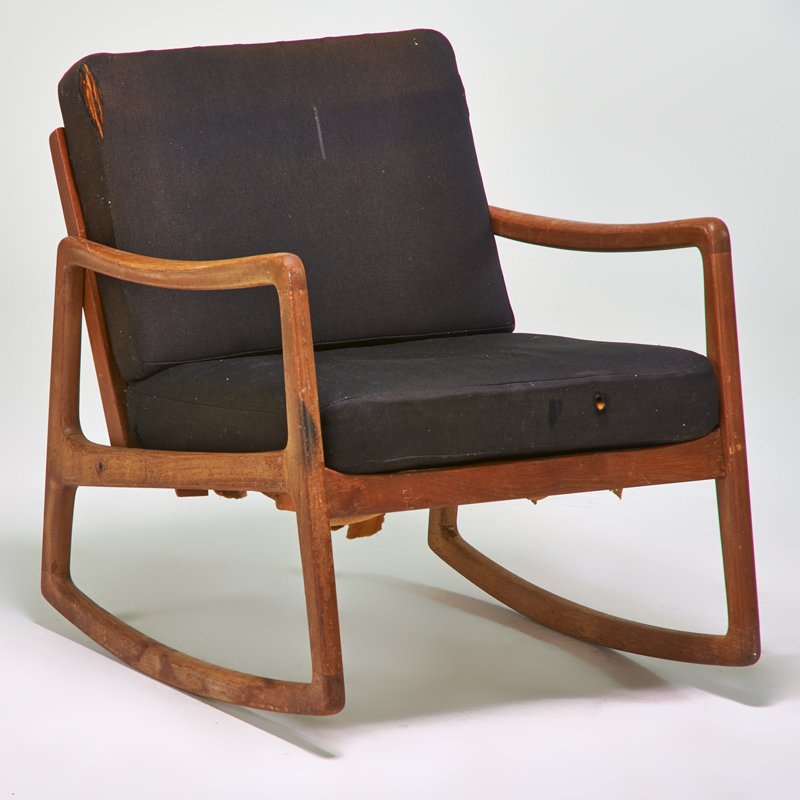 STYLE OF OLE WANSCHER: Rocking chair, Denmark, 1960s; Sculpted teak, upholstery; Unmarked; 30" x 26 1/2" x 31"