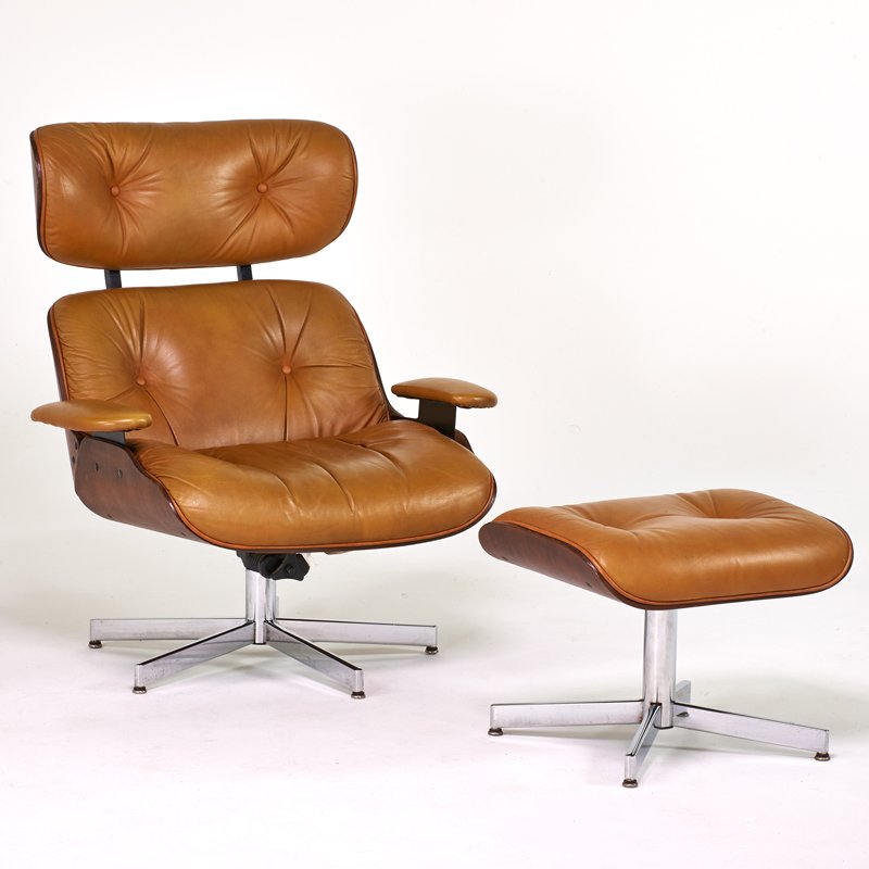 STYLE OF CHARLES EAMES: Lounge chair and ottoman, USA, 1970s; Chromed steel, walnut, leather; Selig manufacturer labels; 39" x 34 1/2" x 33",17" x 22" x 17 1/2"