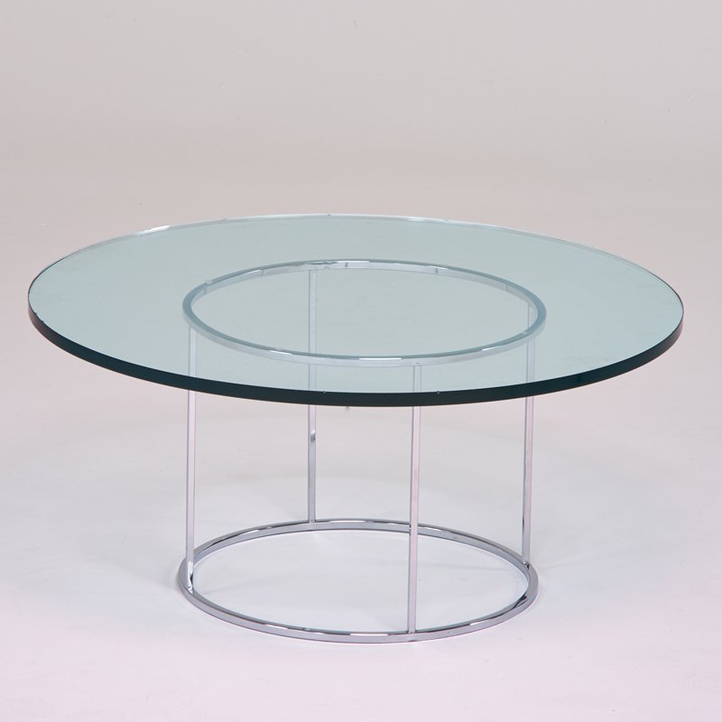 STYLE OF MILO BAUGHMAN: Occasional table, USA, 1970s; Chromed steel, glass; 16" x 35 1/2" dia.
