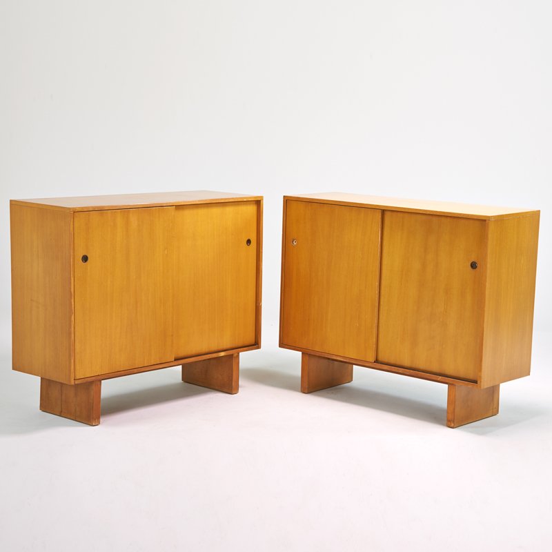 T.H. ROBSJOHN-GIBBINGS; WIDDICOMB MODERN: Pair of sliding door cabinets, Grand Rapids, MI, 1940s; Bleached mahogany, brass; Decal labels; 43" x 51 1/2" x 18 1/2"