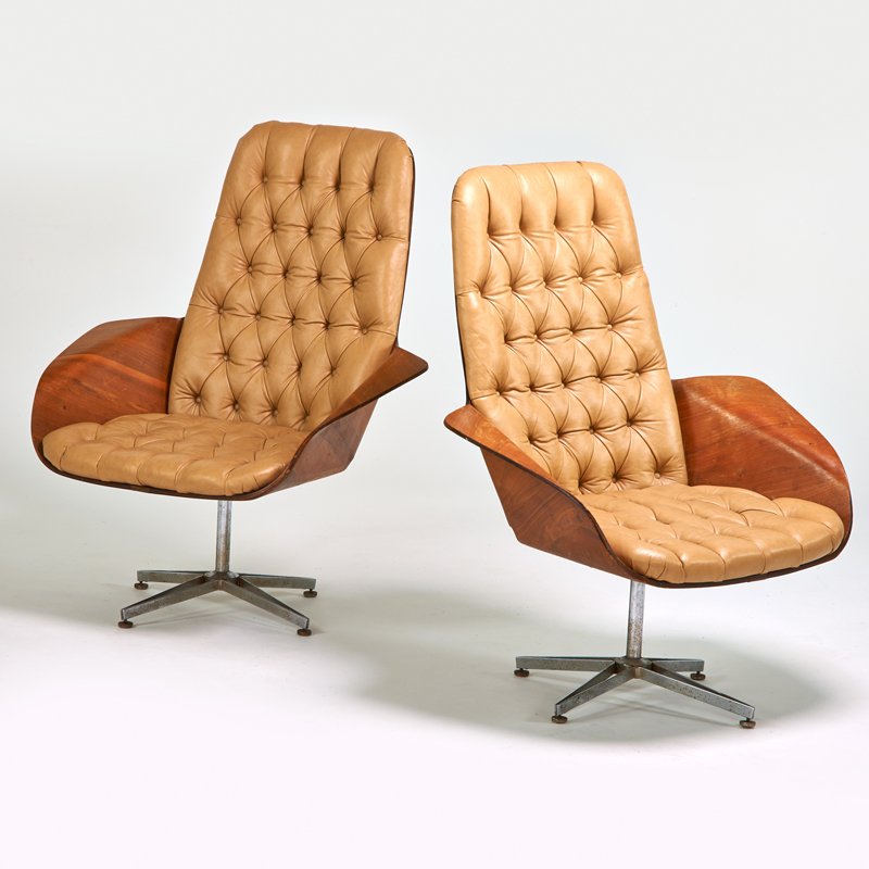 GEORGE MULHAUSER; PLYCRAFT: Pair of swivel lounge chairs, USA, 1950s; Walnut, leather, chromed steel; Foil labels: 43" x 36" x 33"