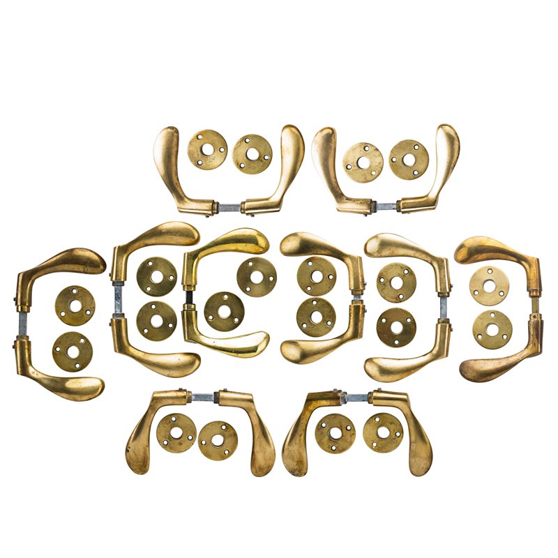 ARNE JACOBSEN Set of ten door handles: ARNE JACOBSEN (1902 - 1971) CARL F. PETERSEN Set of ten patinated brass door handles, Denmark, 1960s UnmarkedWith back plates: 4 3/4" x 2" x 7" Note: Designed for the Scandinavian Airlines System (SAS