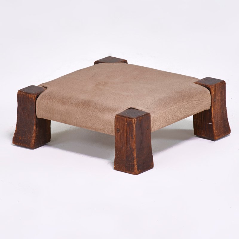 GUSTAV STICKLEY: Gout stool, Eastwood, NY, ca. 1908; Chestnut, leather; Unmarked; 4 1/2" x 12" sq.