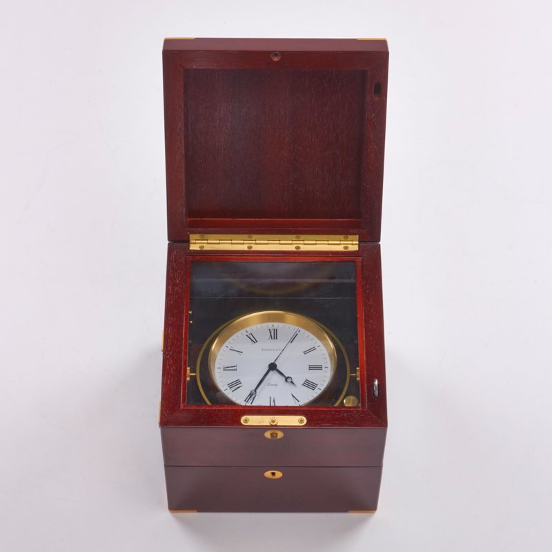 TIFFANY & CO.: Marine clock with assembly and care instructions, Switzerland, 1980s; Brass, cherry; Marked "Tiffany & Co. Swiss Made"; Closed: 7" x 7" x 7"