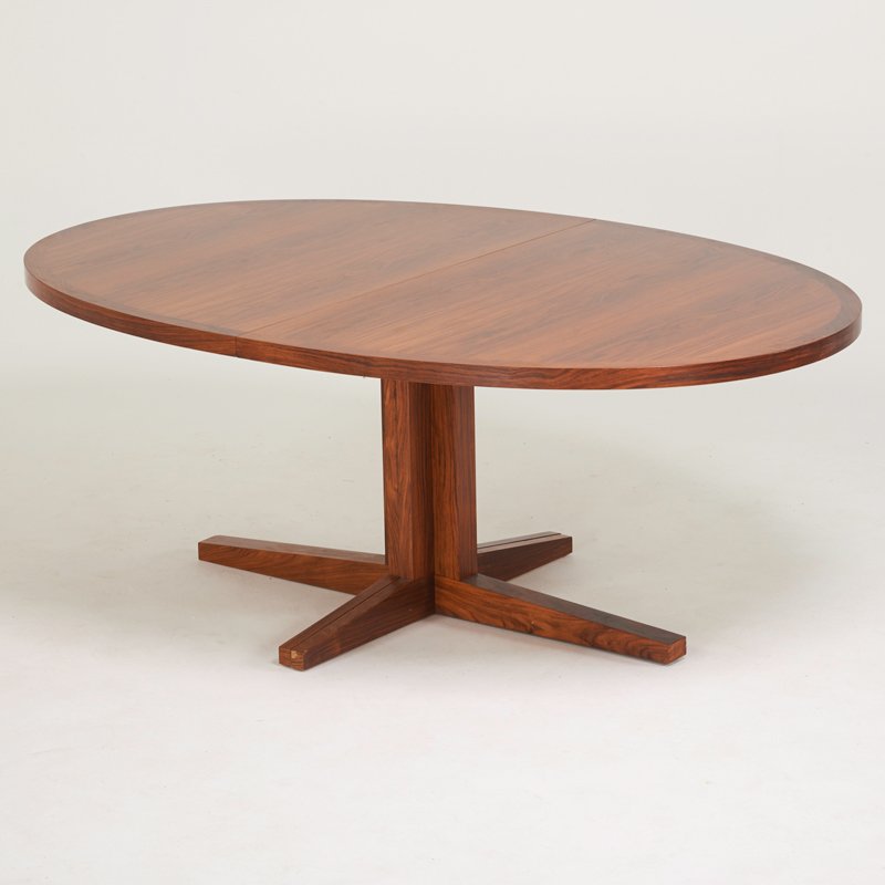 DYRLUND: Rosewood extension dining table, Denmark, 1970s; Manufacturer's label; 28 1/2" x 74" x 48", four leaves: 20"