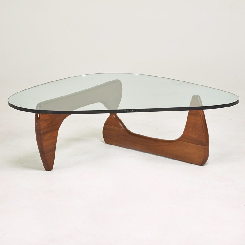 ISAMU NOGUCHI; HERMAN MILLER: "IN-50" coffee table, Zeeland, MI, 1990s; Walnut, glass; Etched signature, Metal manufacturer's label on base; 16" x 50" x 36
