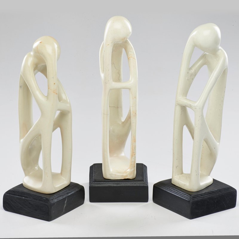 CONTEMPORARY: Three carved soapstone abstract figural sculptures mounted on wooden bases; Unmarked; Tallest: 14 1/2" x 4 3/4" x 4 3/4"