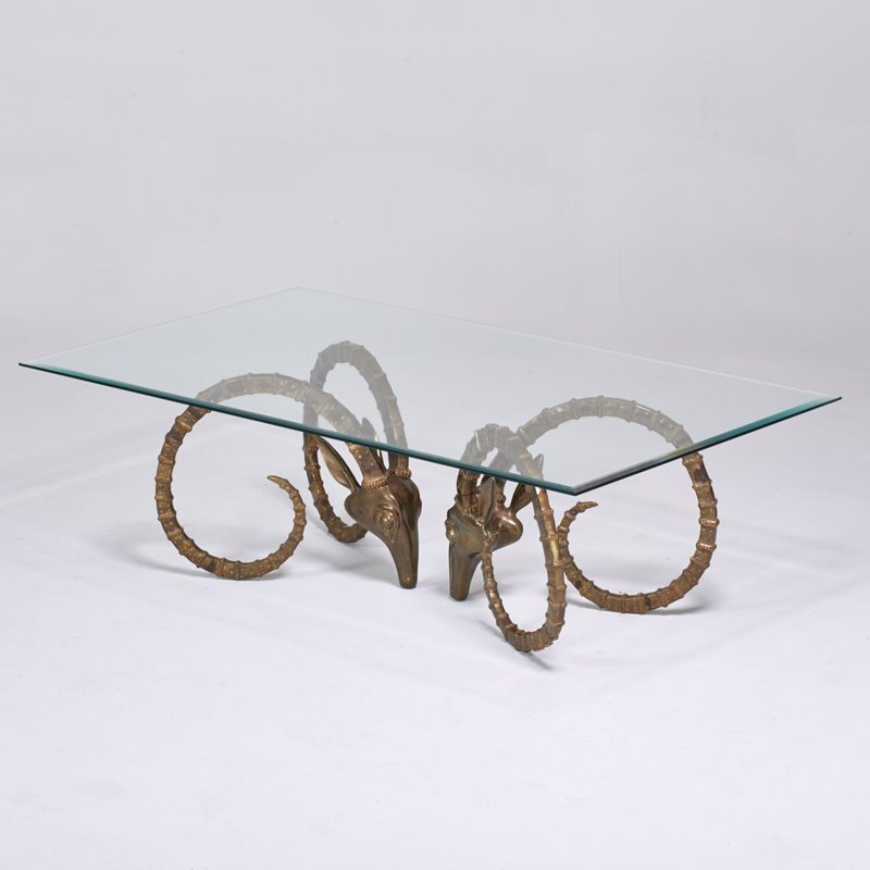 ALAIN CHERVET (Attr.): Coffee table, 1970s; Brass ibex heads, glass; Unmarked; 18" x 58" x 34 1/2"