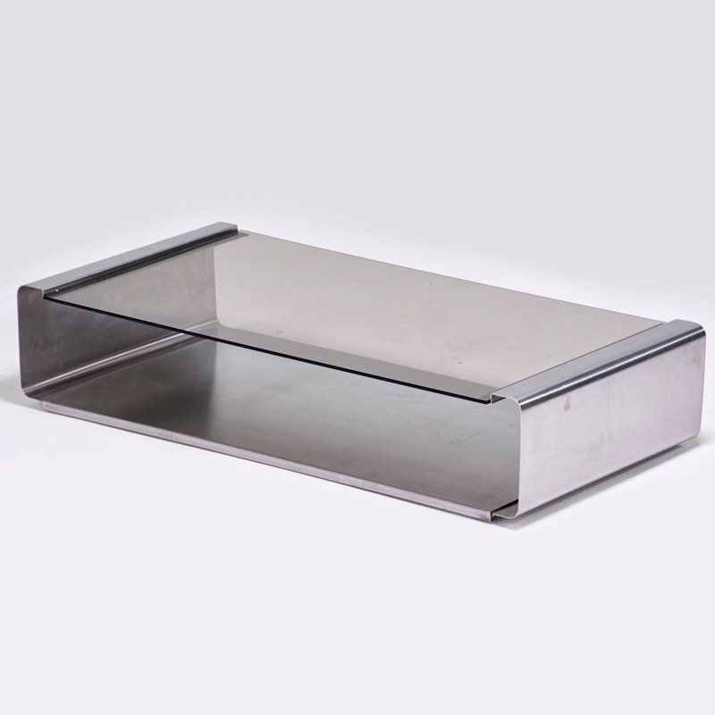FRANCOIS MONNET: Low table, France, 1970s; Stainless steel, glass; Unmarked; 9" x 44" x 22"; Provenace: Richard Wright, May 21, 2006, lot 456