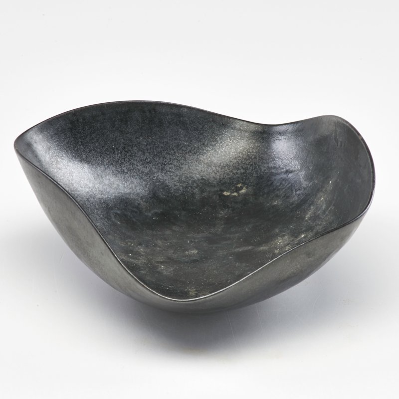 OTTO AND GERTRUD NATZLER: Folded bowl in gunmetal crystalline mat glaze, Los Angeles, 1960s; Signed Natzler; 2 1/2" x 8" x 6 3/4"