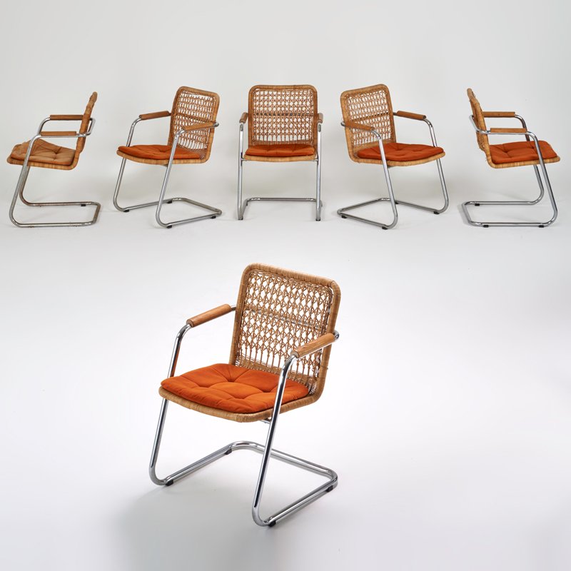 STYLE OF MILO BAUGHMAN: Set of six armchairs, USA, 1970s; Chromed steel, woven wicker, oak armrests, upholstered seats; 32 1/2" x 22" x 23"
