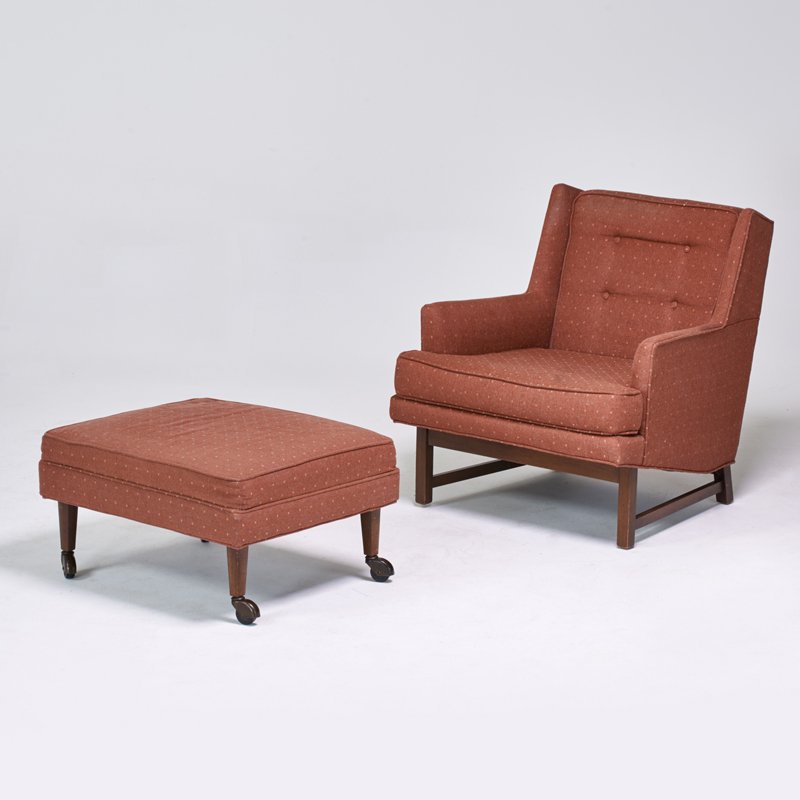 STYLE OF EDWARD WORMLEY: Lounge chair and ottoman, USA, 1950s; Stained wood, upholstery, casters; Chair: 32" x 29" x 35", ottoman" 15" x 28" x 23"