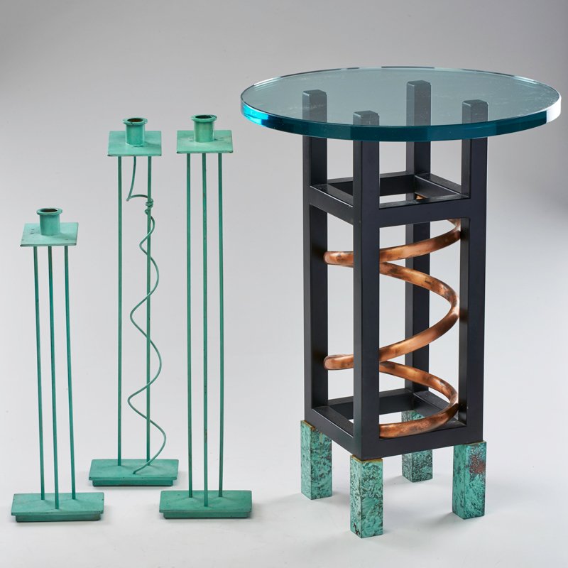 STEPHEN HOLL; SWID POWELL: Five pieces: occasional table, wall mirror, and three candlesticks, Italy, 1980s; Patinated bronze, glass, mirrored glass, copper, enameled metal; Candlesticks signed; Table: 22" x 16"