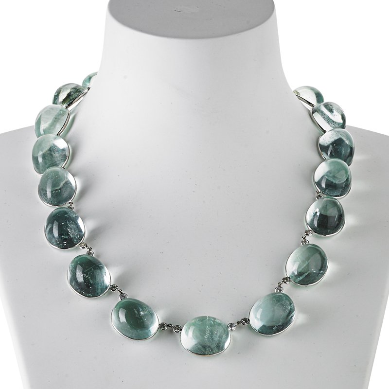 AQUAMARINE AND DIAMOND "POOL OF LIGHT" NECKLACE: 19 oval cabochon aquamarines, approx. 480 cts. TW, set in 14k wg., the front interspersed with 14 RBC diamonds, approx. 1.70 cts. TW. 18". 74.9 dwt. GW