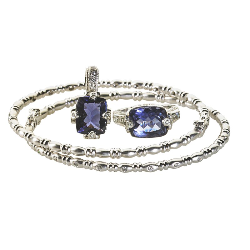 JUDITH RIPKA AND OTHER WHITE GOLD DIAMOND JEWELRY: Four pieces: Judith Ripka iolite and diamond 18k white gold ring, size 6 with sizing beads, and enhancer pendant; Pair of textured 14k wg. hinged bangles with concentric diamond details. Diamonds appr