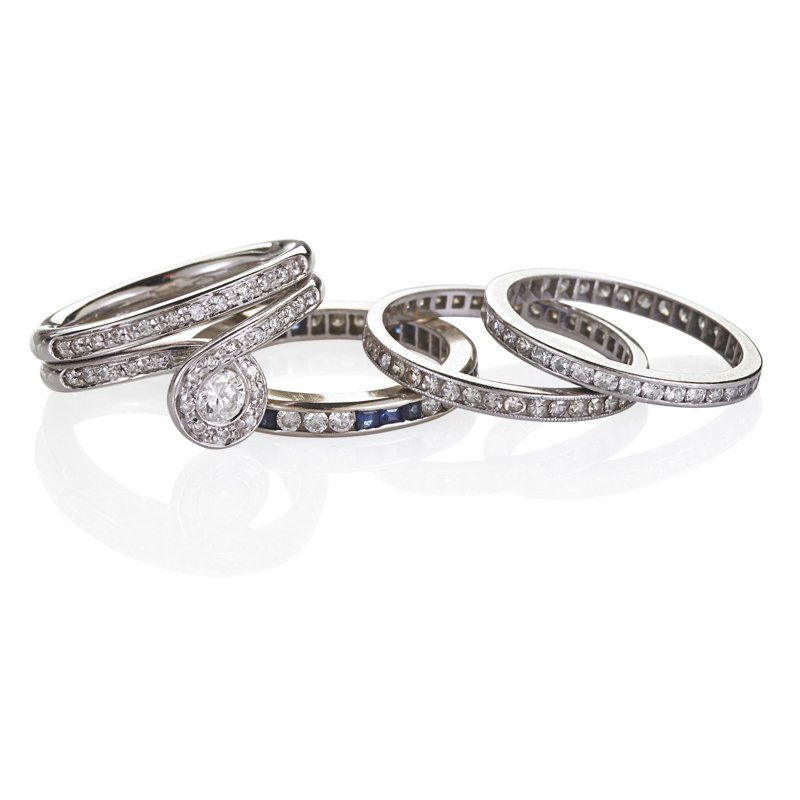 PLATINUM DIAMOND OR SAPPHIRE RING STACK: Four rings: Three bands with RBC diamonds, alternating square cut sapphires; Stylized "snake" ring centers .20 RBC diamond. 1910-2010. Sizes 7 - 8. 9.4 dwt.