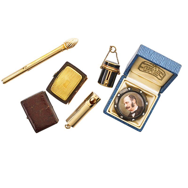 FOUR GOLD ACCESSORIES AND A BROOCH: 18k gold vinaigrette by Joseph Willmore, Birmingham, 1830, with fitted case; Enameled 14k gold 1" lipstick tube on chain; Tiffany & Co. 14k gold saccharine case, 1 1/2"; 14k gold hermetic cosmetic bru