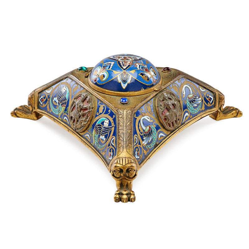 EDWARD F. CALDWELL & CO. CHAMPLEVE INKWELL: Gilt bronze and metal tripod with colored stone and cabochon inserts, early 20th c.; Signed; 4" x 8 1/2"; Literature: Shedding Light on New York: The E.F. Caldwell & Co. Collection, Smithsonian Instit