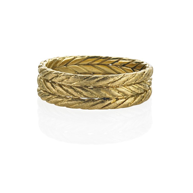 BUCCELLATI, ITALY, 18K GOLD BAND: Three textured rows. Marked Buccellati, Italy, 750, 18k. Graduates 6.03 - 4.77 mm. Size 7 1/2. 3 dwt.