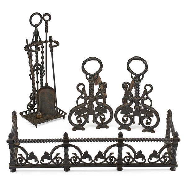 BRADLEY AND HUBBARD FIREPLACE SET: Seven pieces: Pair of andirons, fender, poker, tongs, shovel and holder, all wrought iron, America, early 20th c. Stamped B&H Fender: 9" x 36" x 12"