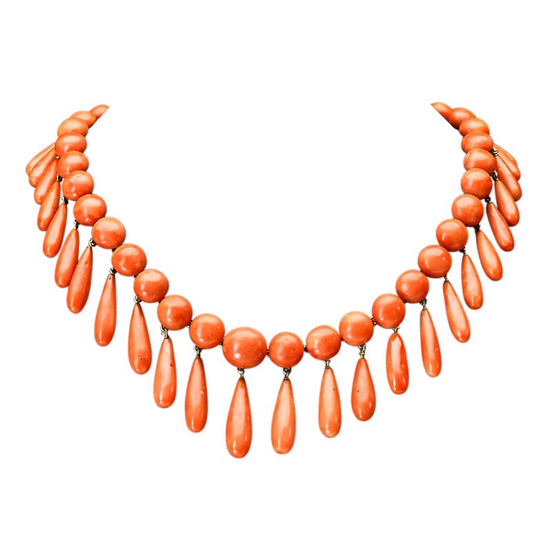 VICTORIAN CORAL AND 18K GOLD FRINGE NECKLACE: Button shaped coral and gold links suspend graduated baton shaped coral drops, ca. 1880. Unmarked. 14" x 1 7/16". 64.8 gs. GW.