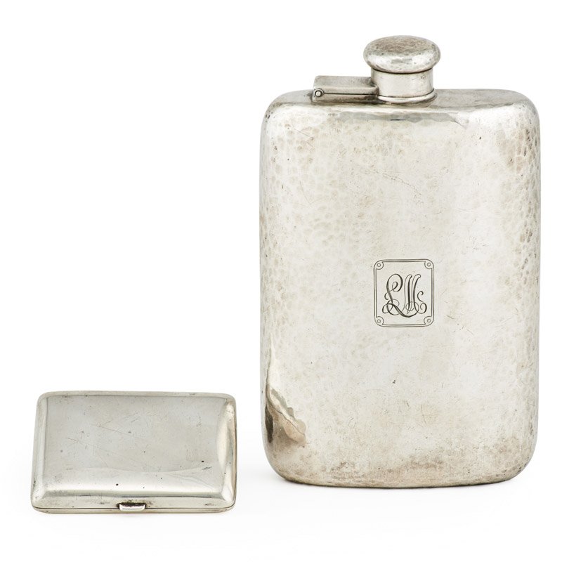 TIFFANY AND CO. STERLING SILVER GROUP: Two pieces: Hammered hip flask and sterling cigarette holder with engine turned and gilt interior, U.S.A., early to mid 20th c.; Flask: 7" x 4 1/2" x 1"; Both marked; 17.25 OT