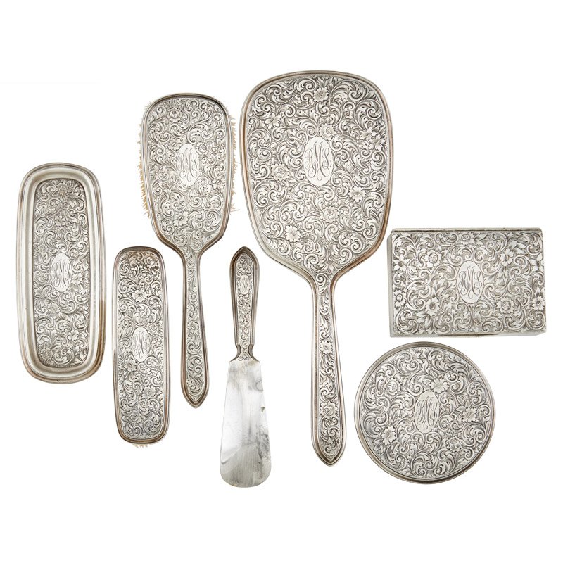 BLACK STARR & FROST STERLING SILVER DRESSER SET: Seven pieces: shoe horn, mirror, lid, tray, velvet lined box and two brushes, each decorated in all over incised foliate and flower design, U.S.A., 20th c.; Marked: Black Starr & Frost / Gorham; Mirro