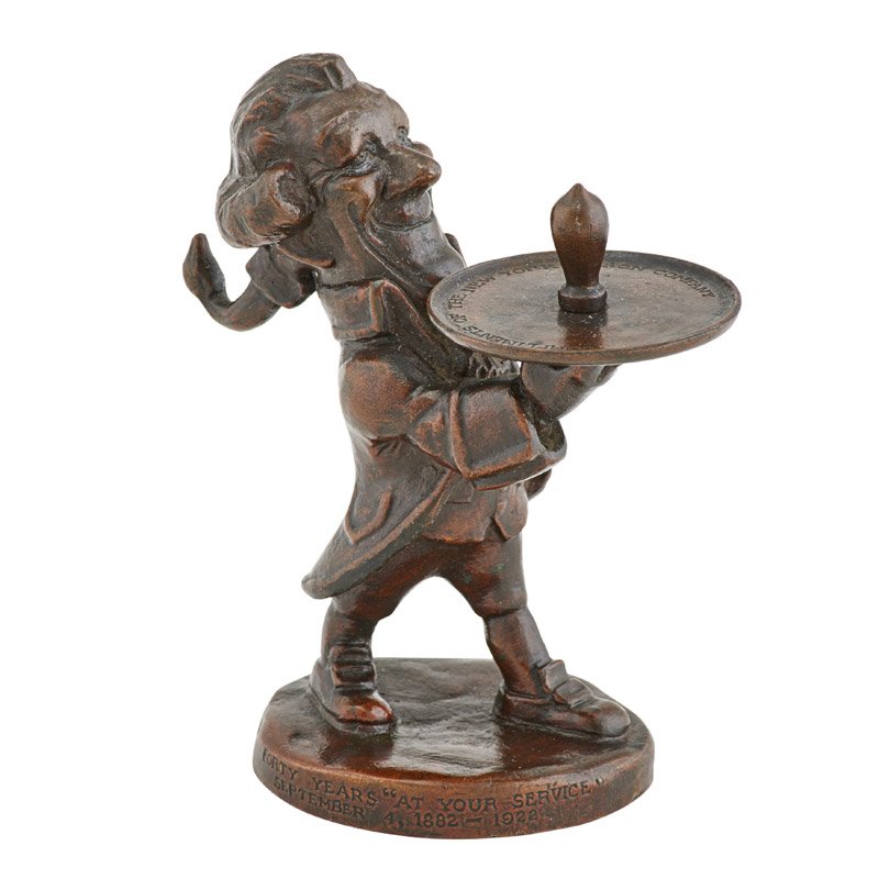BRONZE COMMEMORATIVE ADVERTISING SCULPTURE: Figure of a striding butler delivering a light bulb resting upon a tray, Inscribed: Compliments of the New York Edison Company, after a model by Maxfield Parrish, U.S.A., 1922; Stamped: Gorham Co.; 4