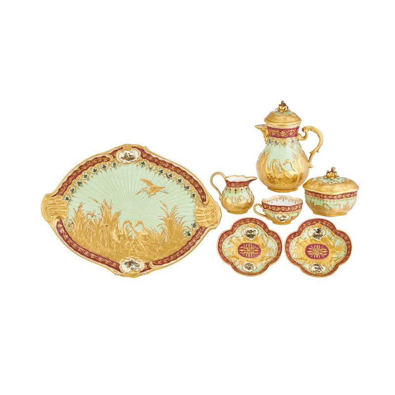 ROYAL VIENNA PORCELAIN TEA SET: Seven pieces: Cup and saucer, tea pot with lid, platter, covered sugar, creamer and saucer, decorated with gilt birds on a green ground, Austria, 19th/20th c.; Marked; Teapot: 8" x 6" x 5"