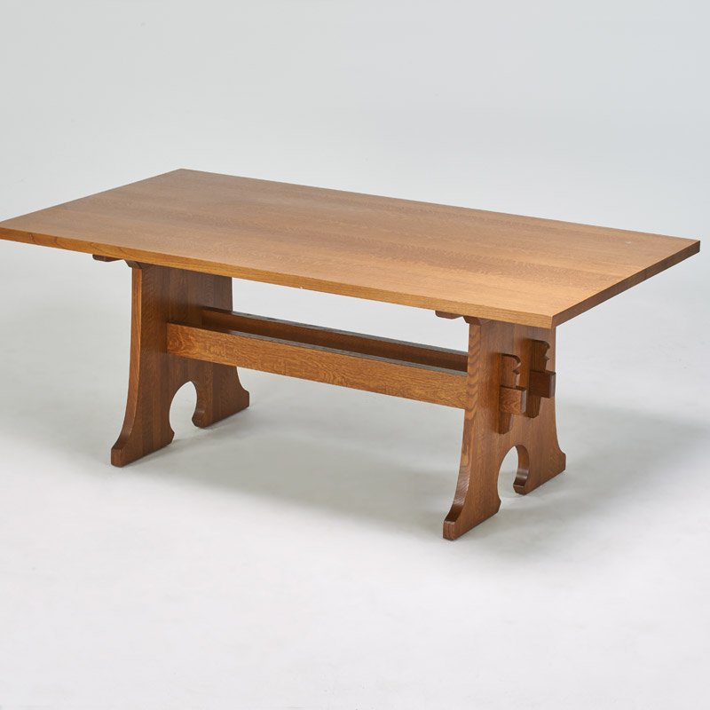 STICKLEY BY E.J. AUDI: Contemporary Mousehole-style trestle dining table, Manlius, NY, ca. 2006; Quarkersawn oak; Metal tag and branded mark; 30 1/2" x 76" x 42 1/4"; with two 15" leaves