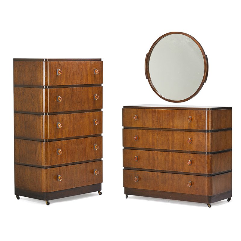 DONALD DESKEY: Mirror and two dressers, USA, 1930s; Walnut, matte-chromed steel, acrylic, mirrored glass; Manufacturer metal labels to dressers; Taller: 52" x 30" x 20", shorter: 28" x 42" x 20", mirror: 30" dia.