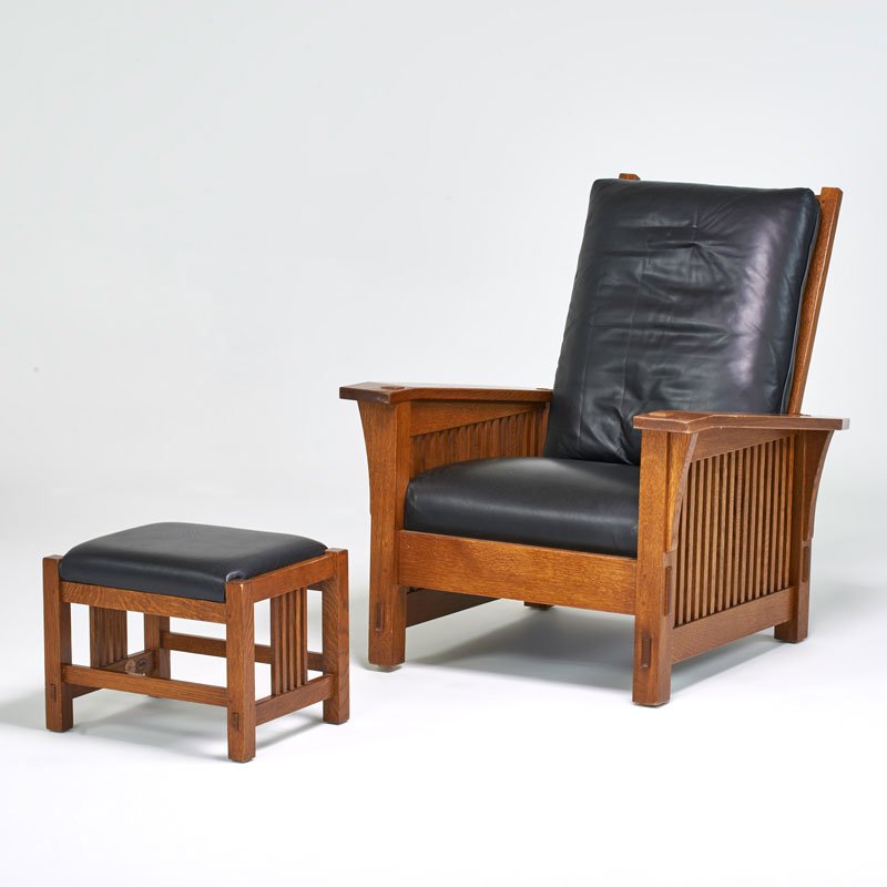 STICKLEY BY E.J. AUDI: Contemporary drop-arm spindled Morris chair and ottoman, Manlius, NY, ca. 1990; Quartersawn oak, leather; Metal tag and branded mark; Chair: 40" x 33" x 43", ottoman: 15" x 19" x 15"
