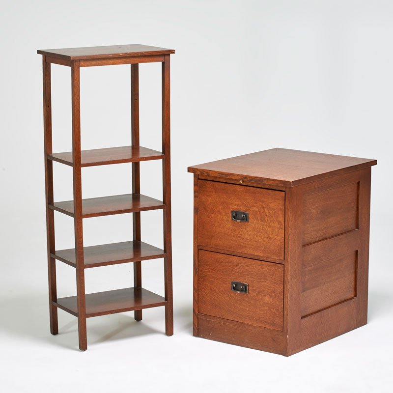 STICKLEY BY E.J. AUDI: Contemporary two-drawer file cabinet and similar tall magazine stand, Manlius, NY, 2000s; Quartersawn oak, patinated metal hardware; Metal tag, branded mark; Cabinet: 31" x 22" x 28", stand: 52" x 20"