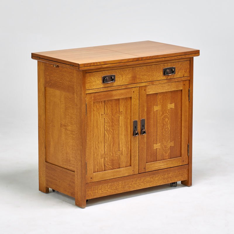 STICKLEY BY E.J. AUDI: Contemporary Arts and Crafts style rolling server with flip-top and drawer over two-doors, Manlius, NY, ca. 1990; Quartersawn oak, copper plated hardware; Closed: 33" x 35" x 20"