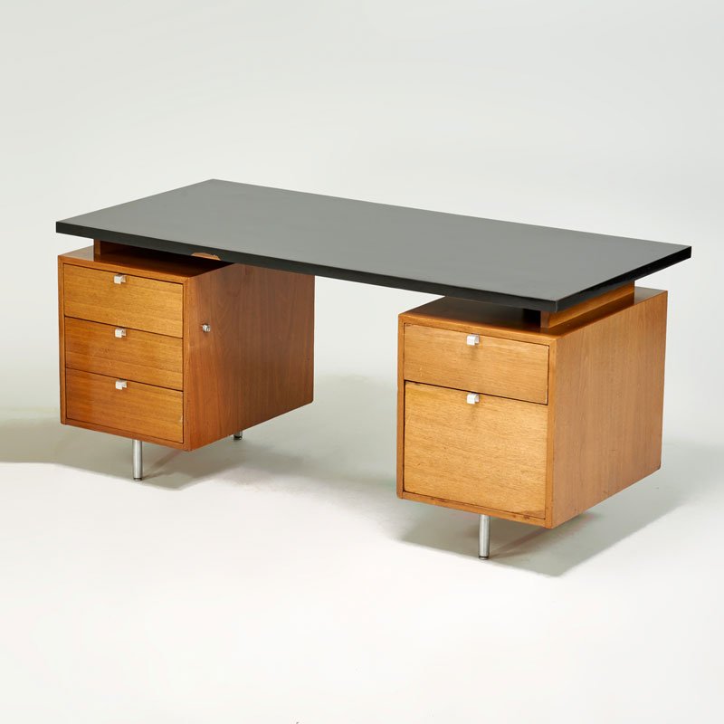 GEORGE NELSON; HERMAN MILLER: Double-pedestal desk, Zeeland, MI, ca. 1950; Walnut, laminated wood, zinc-plated steel; Foil label; Desk: 30" x 64" x 30"