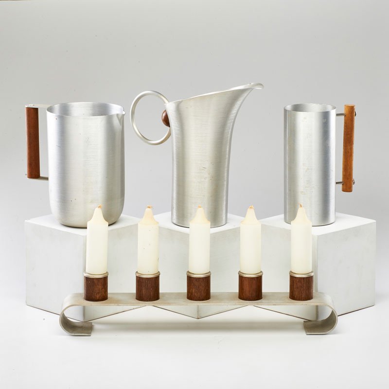 RUSSEL WRIGHT: Four spun aluminum mantle-top pieces with wooden elements: three vessels and candle stand, USA, ca. 1930; Three marked; Tallest: 10" x 11" x 6"