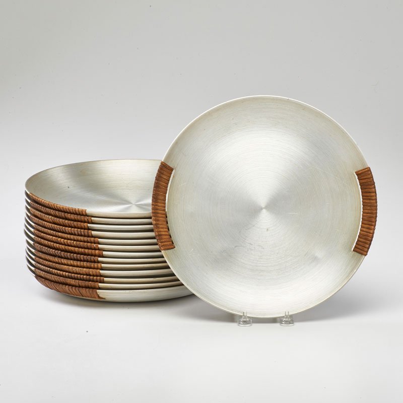 RUSSEL WRIGHT: Fourteen spun aluminum trays with wicker handles, USA, ca. 1930; Thirteen marked; 12" dia.