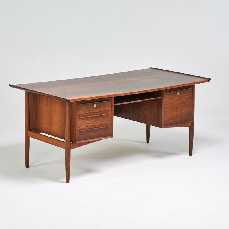 ARNE VODDER: Double-pedestal desk, Denmark, ca. 1960; Rosewood; Ink stamped "Made in Denmark"; 29" x 65" x 31 1/2"