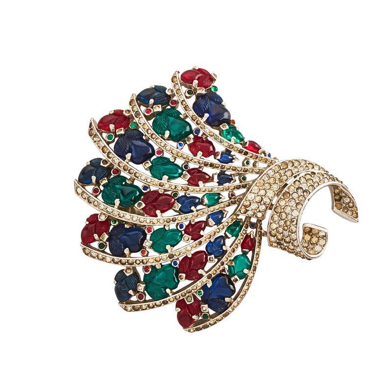 TRIFARI "FRUIT SALAD" BROOCH: A fan of red, green and blue molded glass fruits, and rhinestones in rhodium plated metal. USA, ca. 1940. Designed by Alfred Philippe. Stamped Trifari. 3 1/2" x 3 1/4".