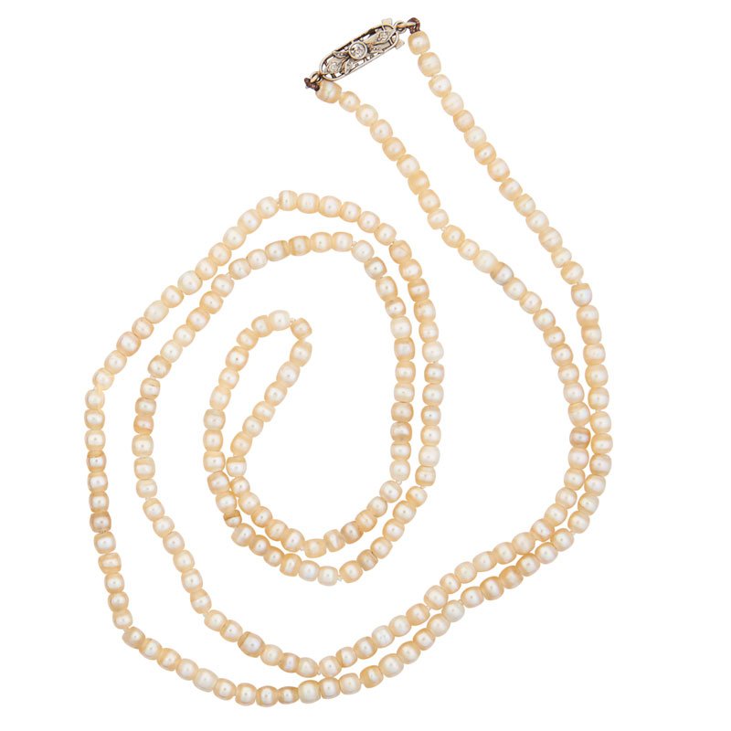 EDWARDIAN LONG STRAND NATURAL PEARLS & DIAMONDS: Comprising 216 fine, well matched, off round white to off white natural saltwater pearls, 3.89 - 3.47 mm, joined by platinum filigree closure, melee approx. .10 ct. TW, ca. 1905. 31". 15.9 gs. Provena