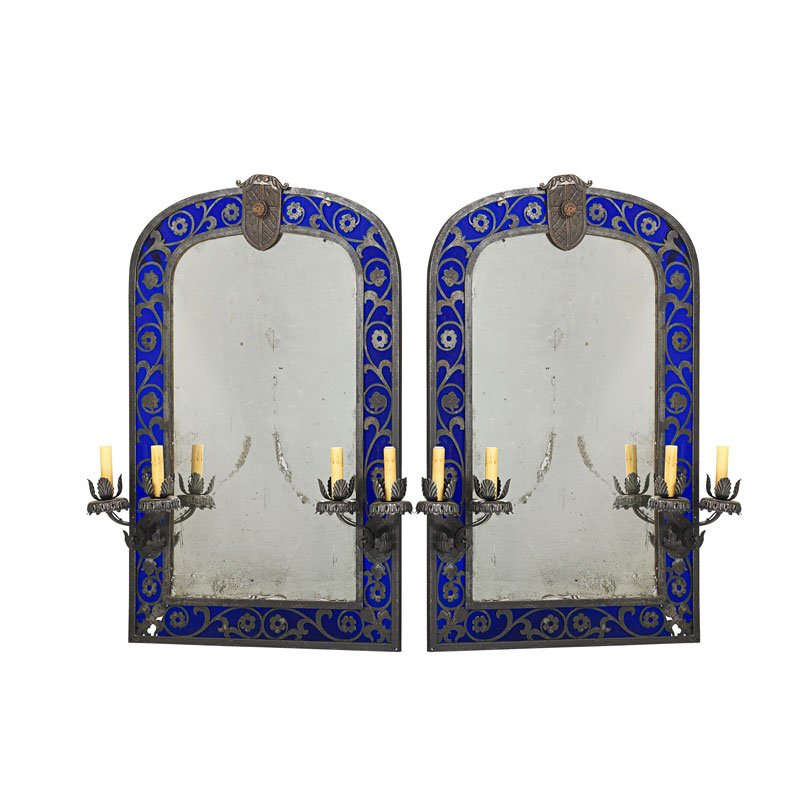 PAIR OF RENAISSANCE STYLE PATINATED METAL MIRRORS: In the manner of Oscar Bach, cobalt border and candle arms, U.S.A, first quarter 20th c.; 37 1/2" x 26 3/4"