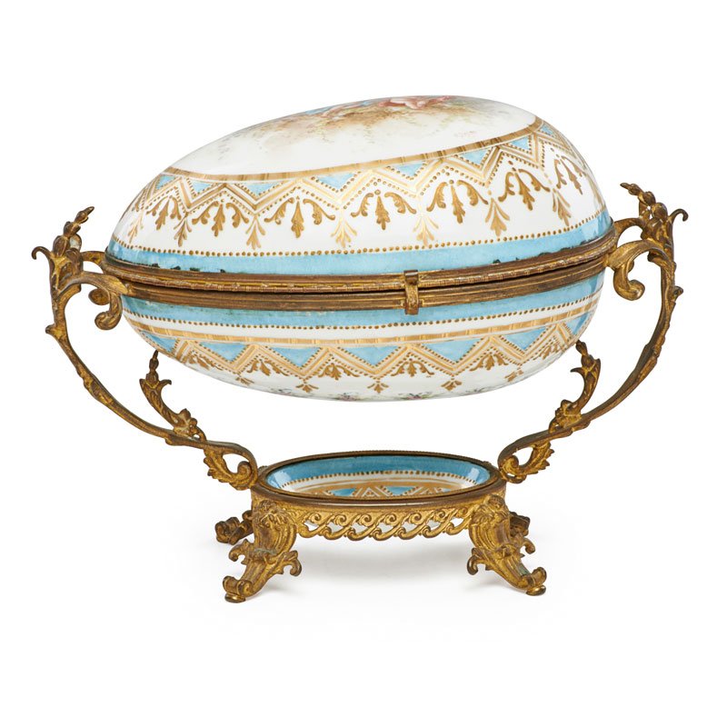 SEVRES STYLE PORCELAIN DRESSER BOX: Egg form with gilt decoration and hand painted cherubs, France, 19th c.; Signed E. Dason; 10" x 12 1/2" x 7 1/2"